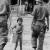 Vietnam del Sud, 1960, Nei villaggi nessuno sa nulla dei guerriglieri Viet Cong (Un bambino trasporta dell’acqua. Nei villaggi nessuno sa nulla dei guerriglieri Viet Cong). Stampa recente alla gelatina ai sali d’argento da negativo originale, 36 x 24 cm, archivio Cascio, Roma